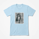 A vintage black and white photograph of a scruffy dog wearing sunglasses printed on a light blue t-shirt